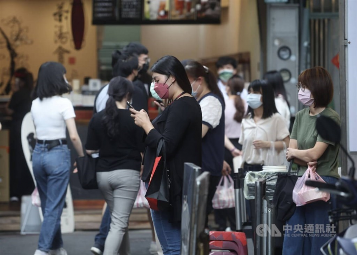 People stand outside stores in the Guang Hua shopping district in Taipei. CNA photo July 4, 2020