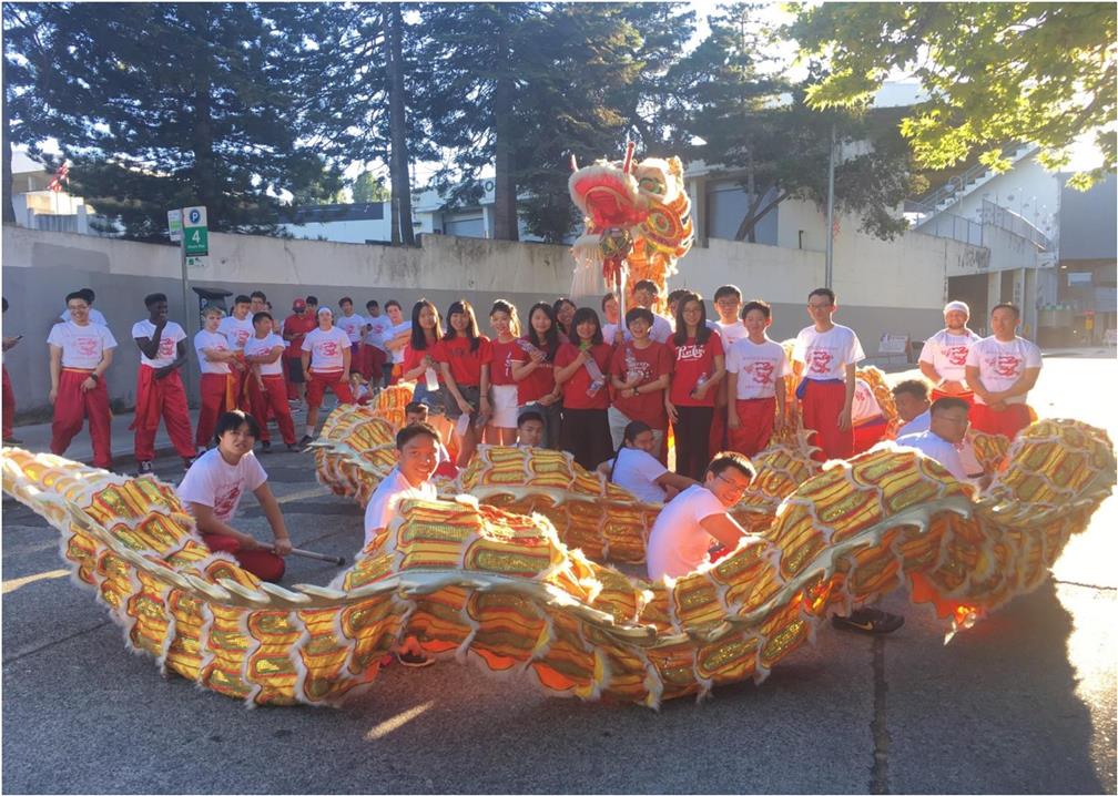 The delegation joins dragon and lion dance team during the Seafair Torchlight Parade.