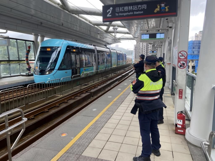 Policemen stand guard at a light rail stop in this illustration photo released by the New Taipei City Police Department on March 1, 2023.