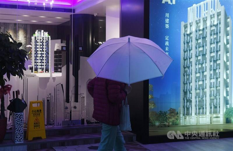 A pedestrian walks past an ad promoting a new housing project. Home buyers turned cautious amid an amended home tax law and uncertainties created by the upcoming elections in the latest consumer confidence survey released on Dec. 27, 2023.