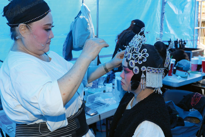 Artist Lee Mei-nyan (left) helps a performer with her hair and makeup backstage.