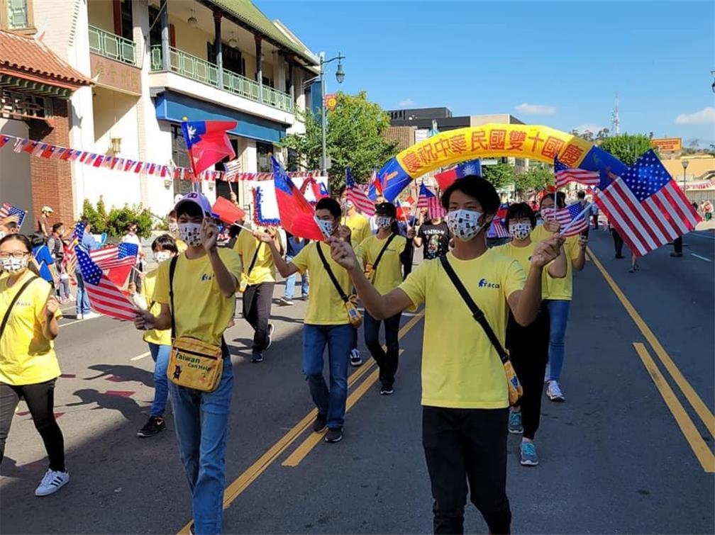 Holding Taiwan flags at the Double Ten Ceremony.