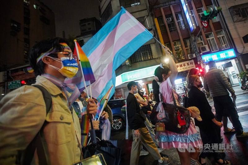 People wave rainbow flags and walk on the street for the the annual Taiwan Trans March that was held on Oct. 28, 2022.