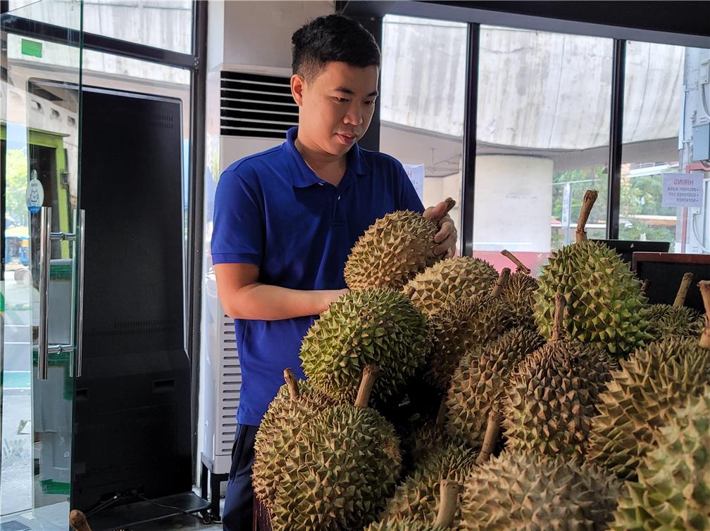 Ethan Chen checks the durians arrived at 