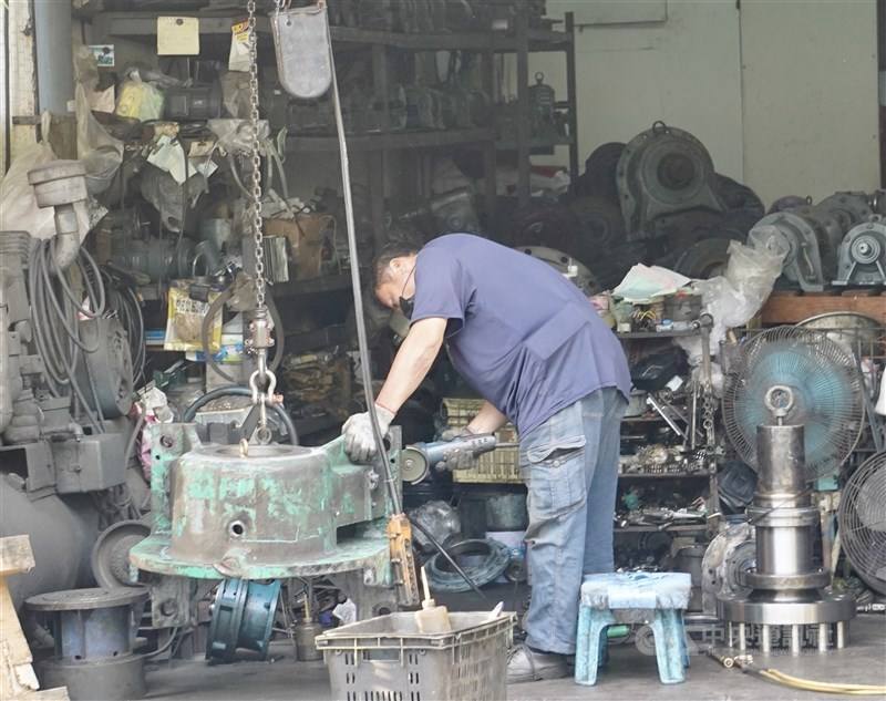 A worker works in a motor factory in Kaohsiung in May.