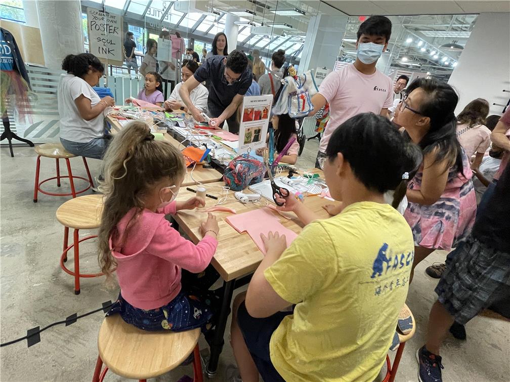 FASCA students lead a community paper art activity.