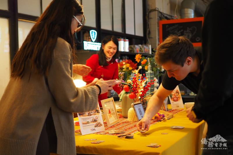 The store owner joins in playing Ang-Ah-Piao at the event.