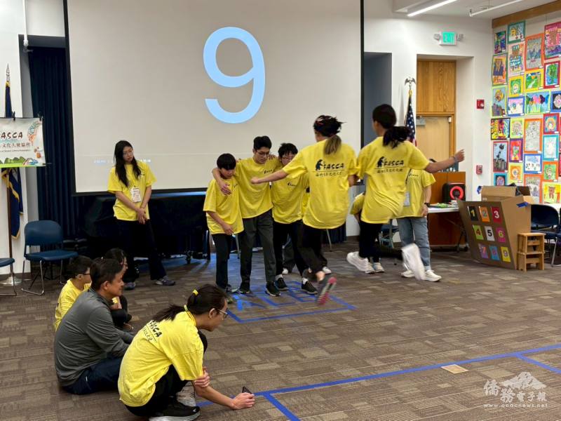 Volunteers jumping into the "Jump into FASCA" box, one of the most energetic challenges of the day.