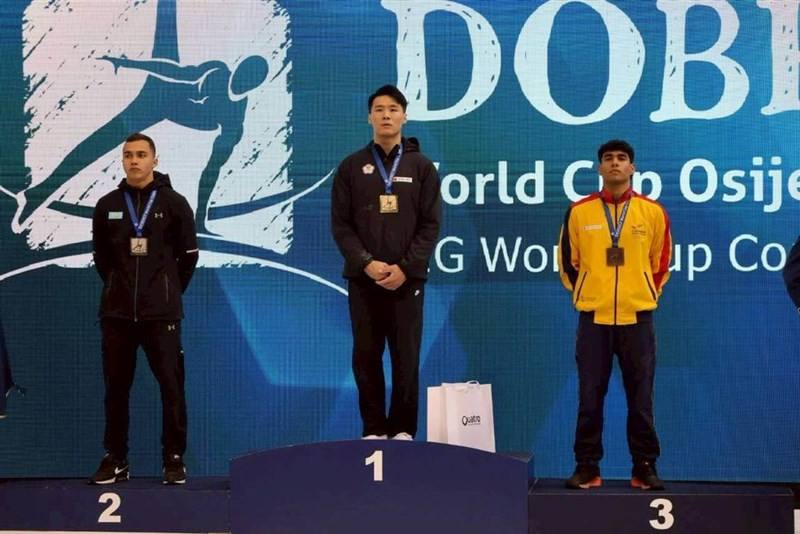 Taiwanese gymnast Tang Chia-hung (center) poses with his gold medal on the podium alongside silver and bronze medalists in Croatia on Sunday.