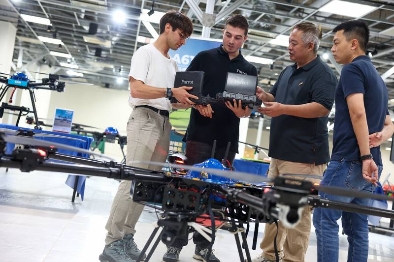 Engineers from Taiwan's 7A Drones engage in a discussion with their French counterparts from Parrot Drones SAS at a facility inside the Asia UAV AI Innovation Application R&D Center in Chiayi County on Sunday.
