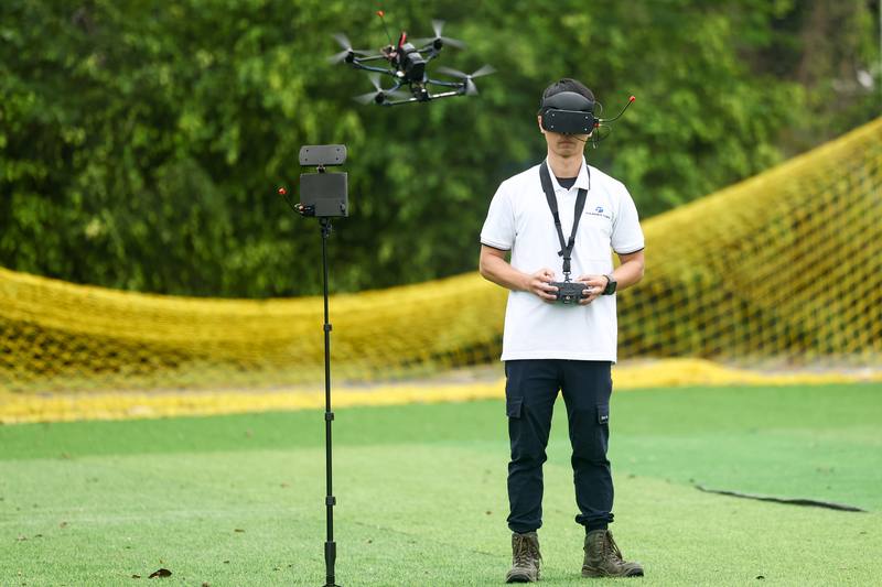 A Thunder Tiger engineer tests out a drone made by his company at the Asia UAV AI Innovation Application R&D Center in Chiayi County on Sunday.