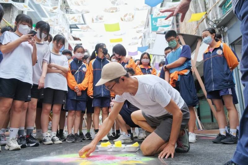 台灣好基金會辦理「2024春潮集」，26日由日本藝術家水內貴英帶領8校學子，在屏東縣潮州鎮建基路老街地面進行噴漆創作，刷新老街新面孔。（台灣好基金會提供）